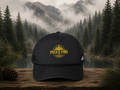 Black Adidas trucker hat featuring embroidered gold Puck & Pine Co. logo, inspired by hockey, cabin life, and outdoor adventure.